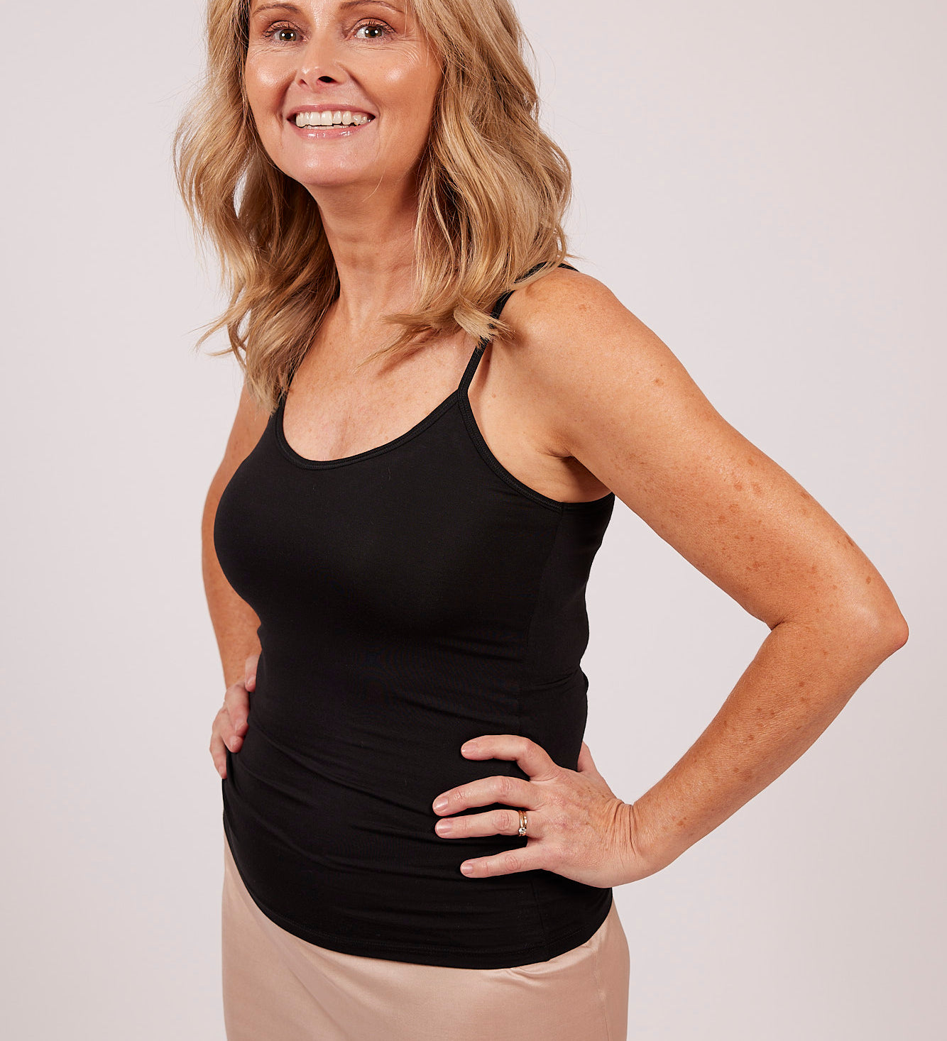 Woman wearing a black EGI modal camisole, showing front view and comfortable fit.