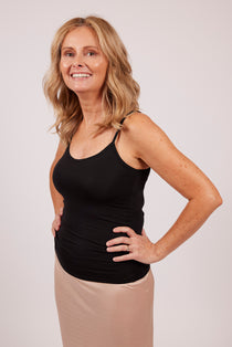 Woman wearing a black EGI modal camisole, showing front view and comfortable fit.
