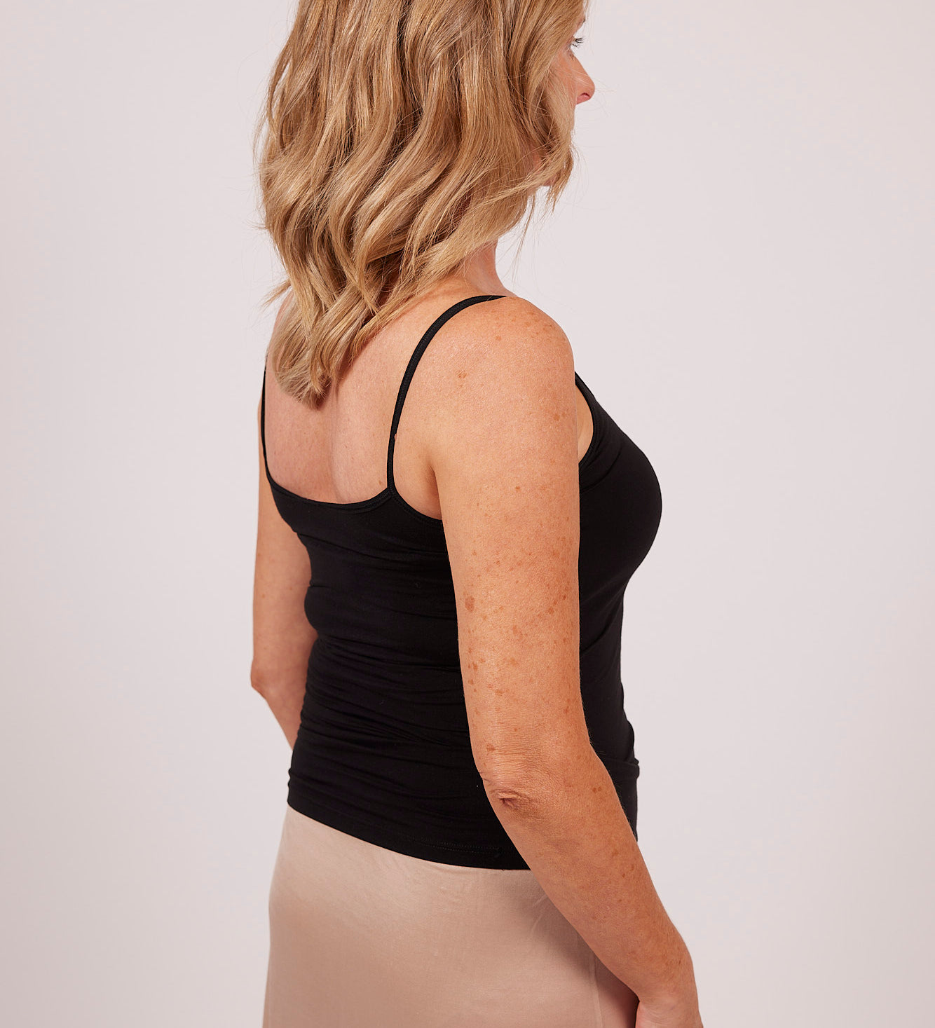 Side view of black modal camisole by EGI, showcasing sleek stretch fit and flattering cut.