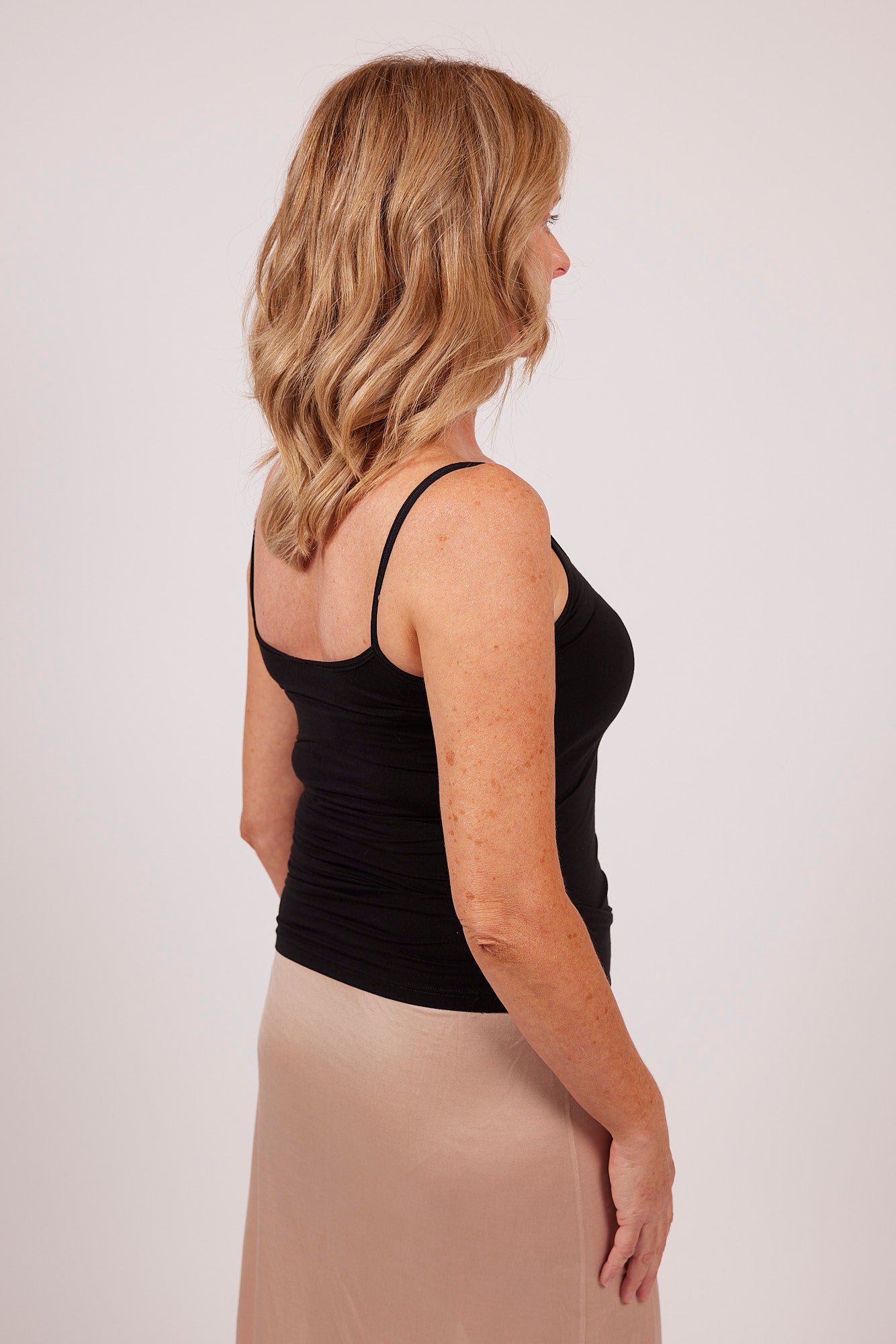 Side view of black modal camisole by EGI, showcasing sleek stretch fit and flattering cut.