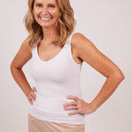 Woman in a white modal tank top by EGI, showing front fit and scoop neckline.