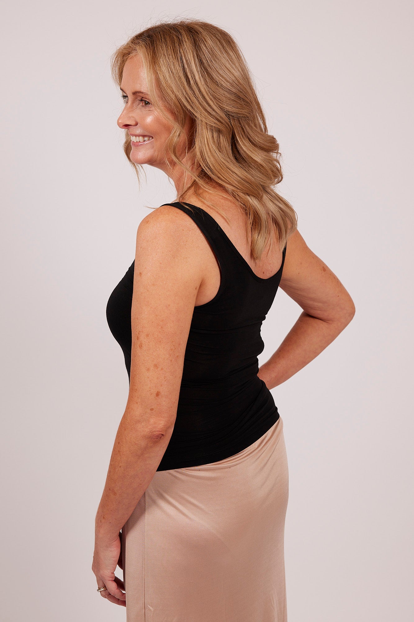 Back-angle view of black modal tank top by EGI, showing shoulder strap style and back fit.