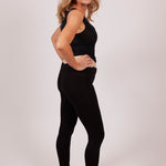 Side view of Viscose Modal Legging in black on model, styled as a sleek, breathable base layer.