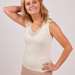 Model wearing Wool & Cotton Doubleface Tank Top in ivory, showing the macramé lace detail and fitted silhouette.