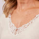 Close-up of Wool & Cotton Doubleface Long Sleeve Top in ivory, highlighting macramé lace v-neck and soft cotton lining.
