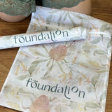 The Foundation Wash Bag shown with lingerie, featuring mesh fabric and Australian Botanical Print design.