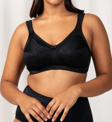 Model wearing the Triumph Endless Comfort Wirefree Bra in Black, showcasing full-coverage fit—available at The Foundation.