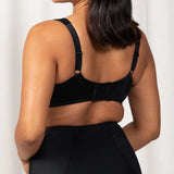 Back view of the Triumph Endless Comfort Wirefree Bra in Black with smooth finish and 4-hook closure—available at The Foundation.