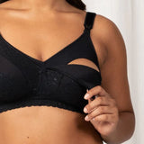 Close up of The Foundation’s Lace Maternity Bra in use, showing drop-down cup open for nursing, designed for practicality and comfort.