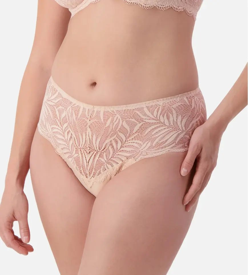 Side angle of model in Triumph Essential Lace Maxi Brief Nude Pink highlighting delicate lace and flirty, flattering cut.
