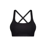 Flat lay of Triumph Triaction Ultra Seamfree Top Black, seamless crop sports bra, moisture-wicking fabric, cross-back design, Triumph Triaction range.