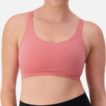 Triaction Ultra Seamfree Top in Salsa Pink by Triumph shown on model, wireless activewear crop with cross-back straps and double-layered support 