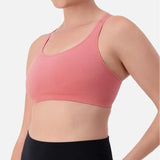 Triaction Ultra Seamfree Top in Salsa Pink by Triumph shown on model, wireless activewear crop with cross-back straps and double-layered support 