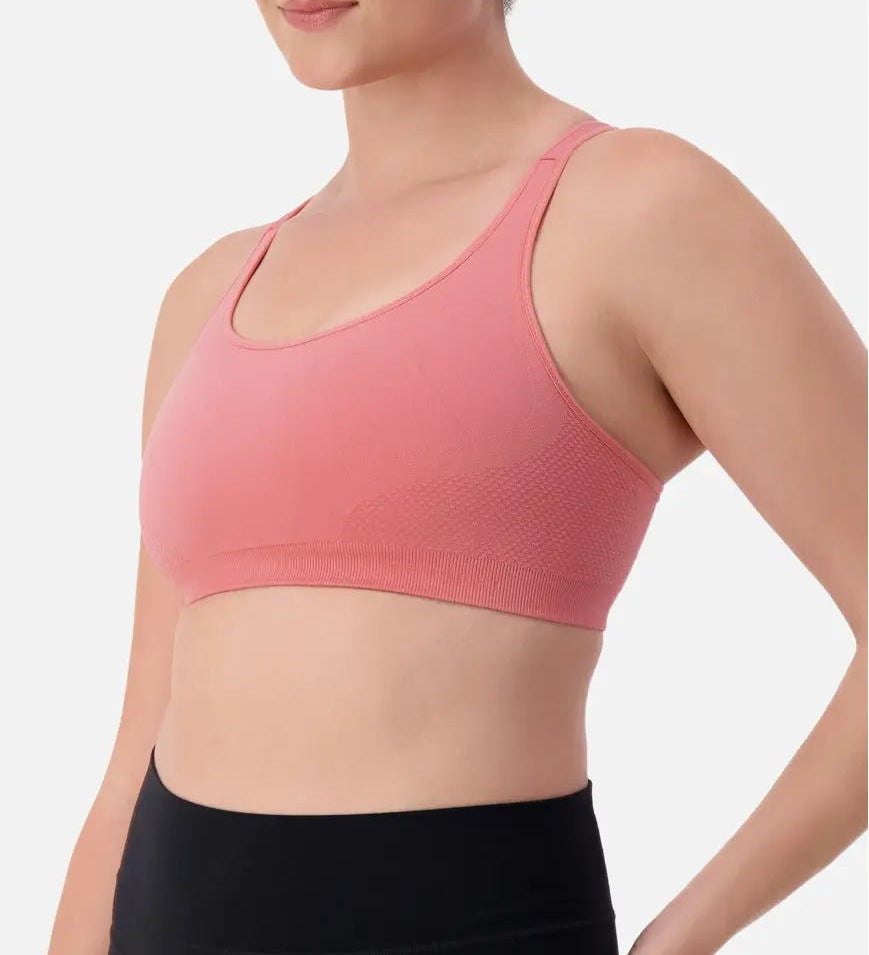 Triaction Ultra Seamfree Top in Salsa Pink by Triumph shown on model, wireless activewear crop with cross-back straps and double-layered support 