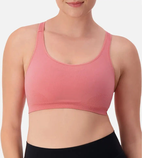 Triaction Ultra Seamfree Top in Salsa Pink by Triumph shown on model, wireless activewear crop with cross-back straps and double-layered support 