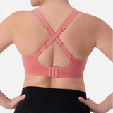 Triaction Ultra Seamfree Top in Salsa Pink by Triumph shown on model, wireless activewear crop with cross-back straps and double-layered support 
