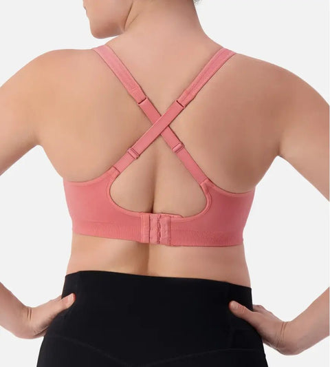 Triaction Ultra Seamfree Top in Salsa Pink by Triumph shown on model, wireless activewear crop with cross-back straps and double-layered support 
