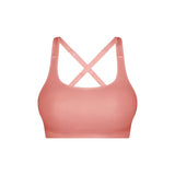 Triaction Ultra Seamfree Top in Salsa Pink by Triumph shown on model, wireless activewear crop with cross-back straps and double-layered support 