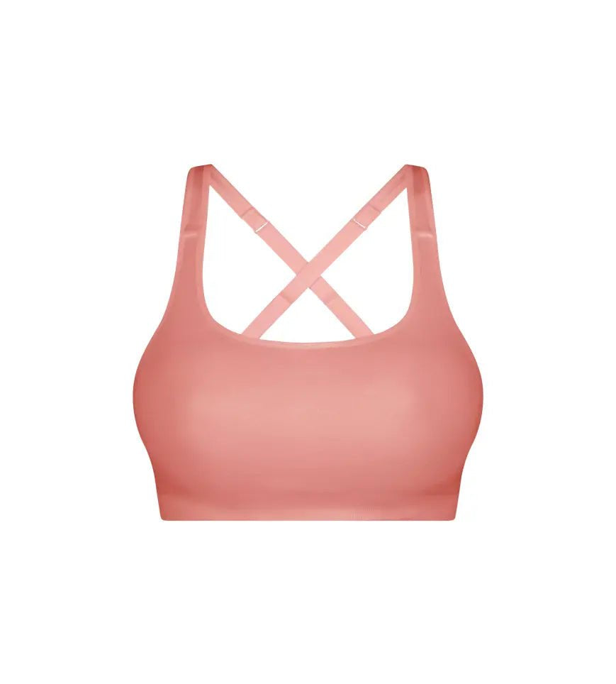 Triaction Ultra Seamfree Top in Salsa Pink by Triumph shown on model, wireless activewear crop with cross-back straps and double-layered support 