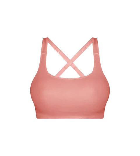 Triaction Ultra Seamfree Top in Salsa Pink by Triumph shown on model, wireless activewear crop with cross-back straps and double-layered support 