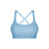 Flat lay of Triumph Triaction Ultra Seamfree Top Sky Blue, seamless sports bra, moisture-wicking activewear, cross-back detail, new limited edition colour.