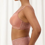Side angle of The Foundation’s Amourette Charm Wire-Free Bra in Rust, styled with matching brief for a feminine look.