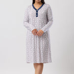 Woman wearing a patterned nightgown on a white background