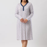 Woman wearing a patterned nightgown on a white background