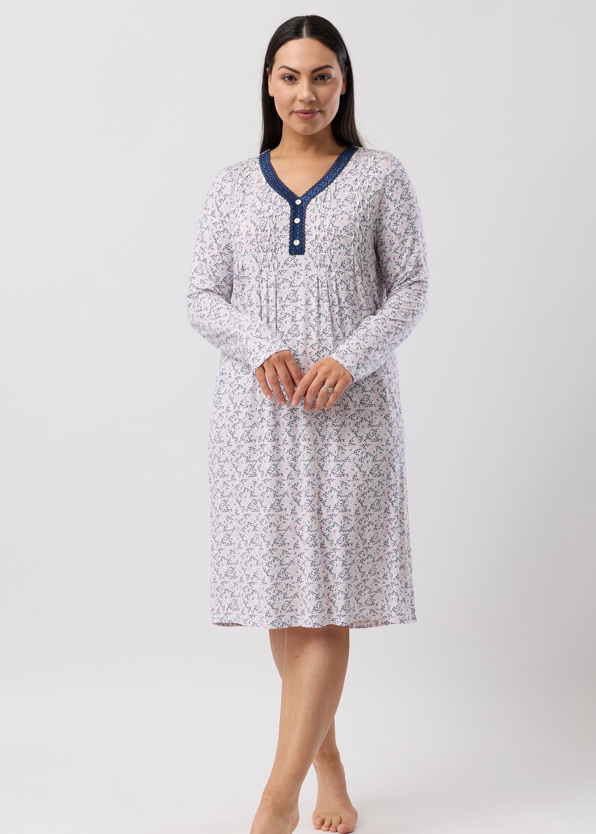 Woman wearing a patterned nightgown on a white background