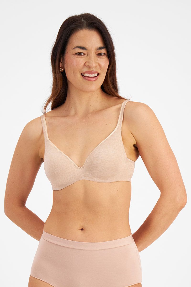 Model wearing Berlei Barely There Contour Bra Skin – seamless, comfy t-shirt bra with full-cup support.