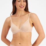 Model wearing Berlei Barely There Contour Bra Skin – seamless, comfy t-shirt bra with full-cup support.