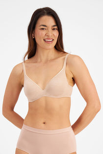 Model wearing Berlei Barely There Contour Bra Skin – seamless, comfy t-shirt bra with full-cup support.