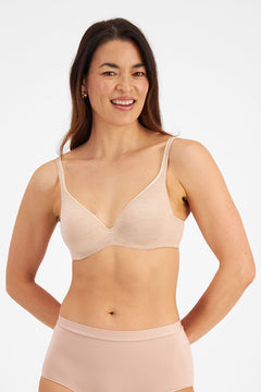 Model wearing Berlei Barely There Contour Bra Skin – seamless, comfy t-shirt bra with full-cup support.