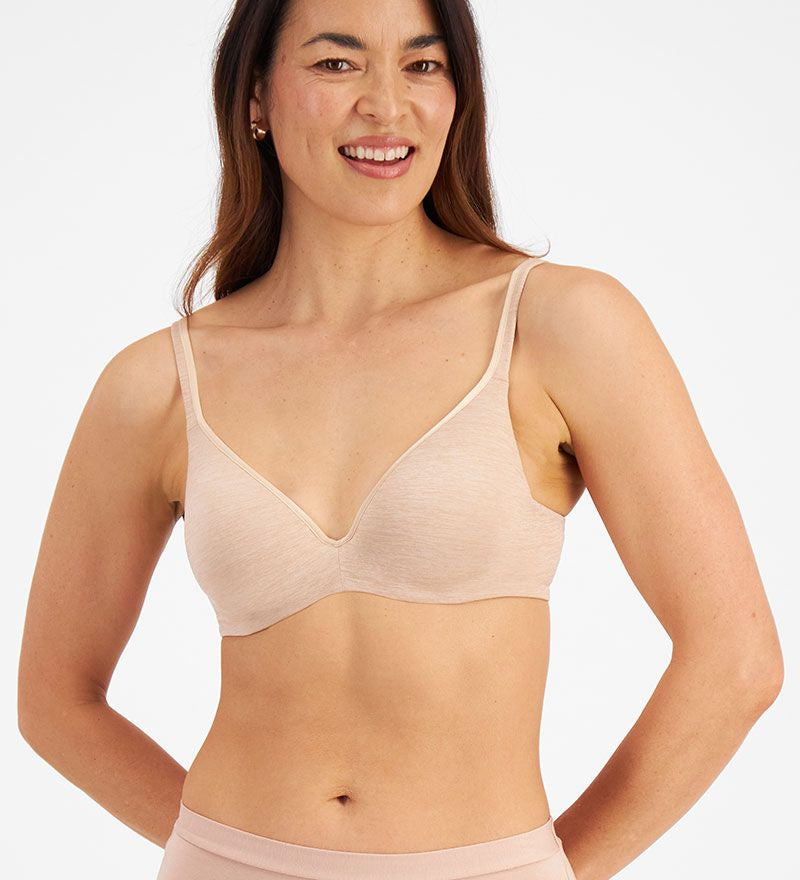 Model wearing Berlei Barely There Contour Bra Skin – seamless, comfy t-shirt bra with full-cup support.