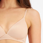 Close up of Berlei Understate Wirefree Bra Nude—soft neckline and smooth lines for seamless wear under clothes.