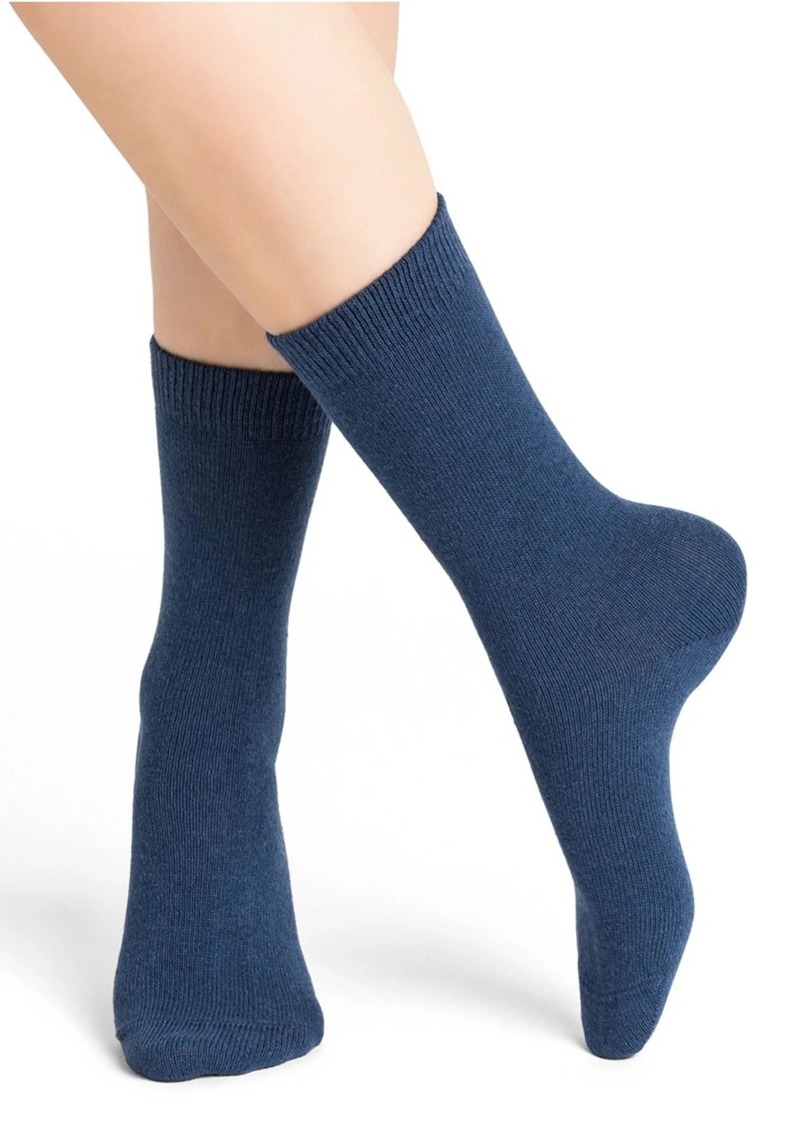 Bleuforêt Wool Cashmere Socks in Mid Admiral blue worn with bare legs, showing soft knit texture and mid-calf height, stocked at The Foundation.