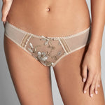 Close up of model in Empreinte Lauren Bikini Brief Or Ancien Ivory highlighting intricate embroidery and flattering bikini style.
