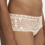 Model wearing Chantelle Day To Night Shorty Brief in Golden Beige, featuring delicate lace detailing, soft mesh lining, and a flattering hipster cut. side view