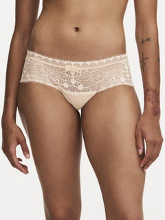 Model wearing Chantelle Day To Night Shorty Brief in Golden Beige, featuring delicate lace detailing, soft mesh lining, and a flattering hipster cut. front