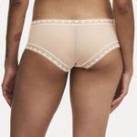 Model wearing Chantelle Day To Night Shorty Brief in Golden Beige, featuring delicate lace detailing, soft mesh lining, and a flattering hipster cut. back view