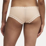 Model wearing Chantelle Day To Night Shorty Brief in Golden Beige, featuring delicate lace detailing, soft mesh lining, and a flattering hipster cut. back view