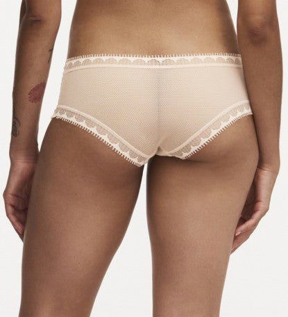 Model wearing Chantelle Day To Night Shorty Brief in Golden Beige, featuring delicate lace detailing, soft mesh lining, and a flattering hipster cut. back view