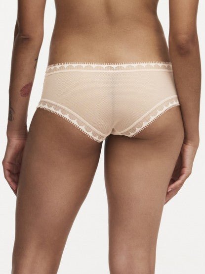 Model wearing Chantelle Day To Night Shorty Brief in Golden Beige, featuring delicate lace detailing, soft mesh lining, and a flattering hipster cut. back view