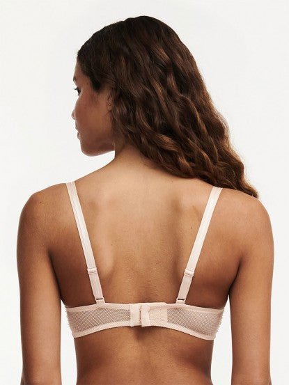 Model wearing Chantelle Day to Night Half Cup Bra in Golden Beige, featuring refined lace, demi cups, and soft adjustable straps for a lifted fit. back view