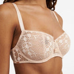 Model wearing Chantelle Day to Night Half Cup Bra in Golden Beige, featuring refined lace, demi cups, and soft adjustable straps for a lifted fit. close up