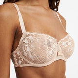 Model wearing Chantelle Day to Night Half Cup Bra in Golden Beige, featuring refined lace, demi cups, and soft adjustable straps for a lifted fit. close up