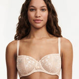 Model wearing Chantelle Day to Night Half Cup Bra in Golden Beige, featuring refined lace, demi cups, and soft adjustable straps for a lifted fit. front view