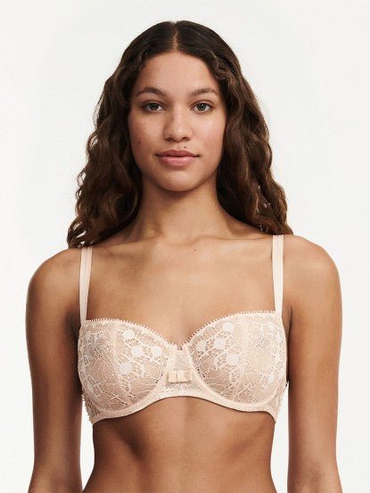 Model wearing Chantelle Day to Night Half Cup Bra in Golden Beige, featuring refined lace, demi cups, and soft adjustable straps for a lifted fit. front view