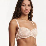Model wearing Chantelle Day to Night Half Cup Bra in Golden Beige, featuring refined lace, demi cups, and soft adjustable straps for a lifted fit. side view