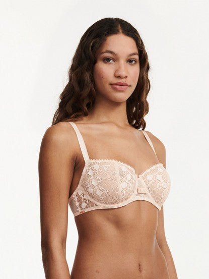 Model wearing Chantelle Day to Night Half Cup Bra in Golden Beige, featuring refined lace, demi cups, and soft adjustable straps for a lifted fit. side view
